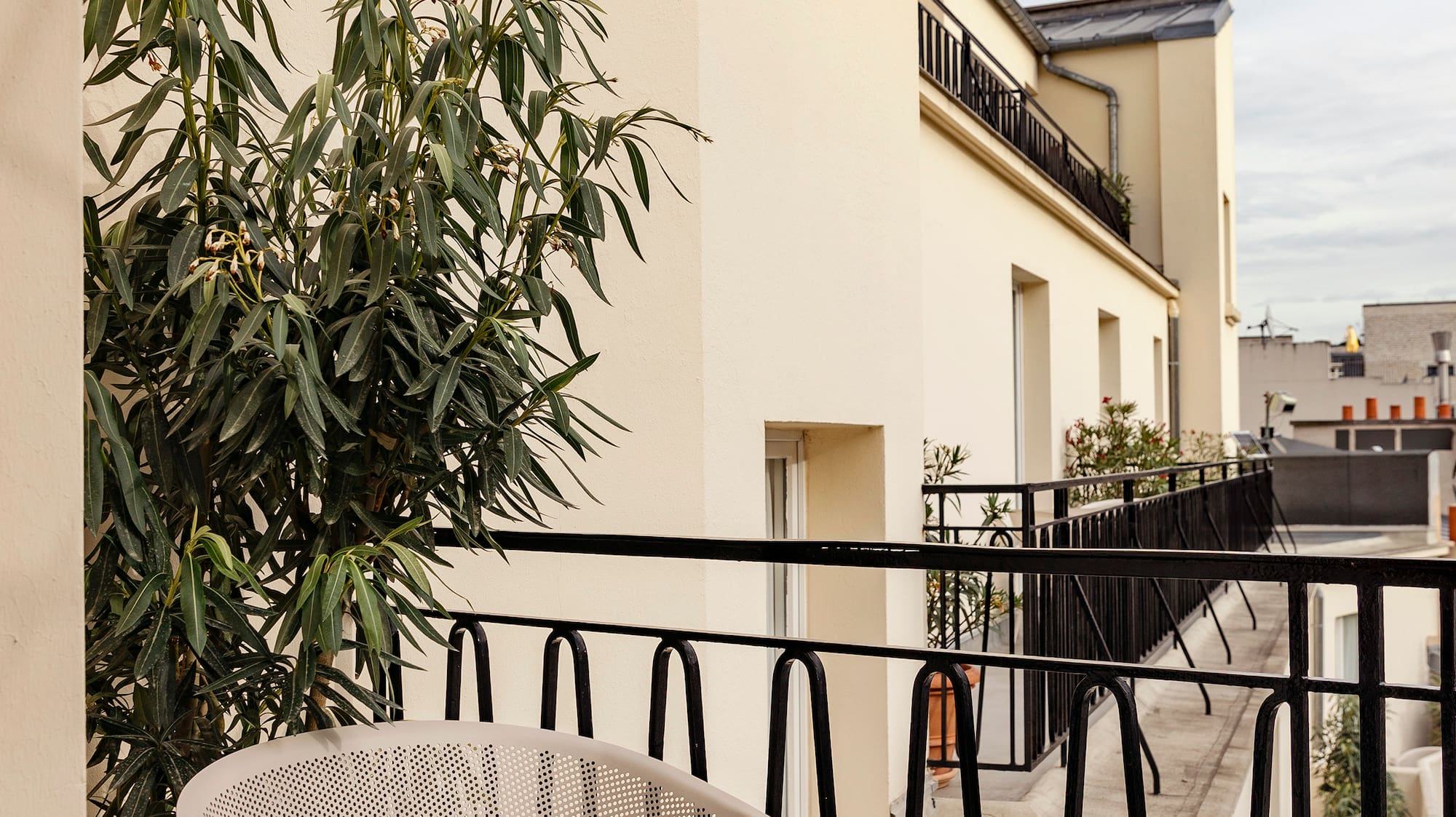 a chair and table on a balcony