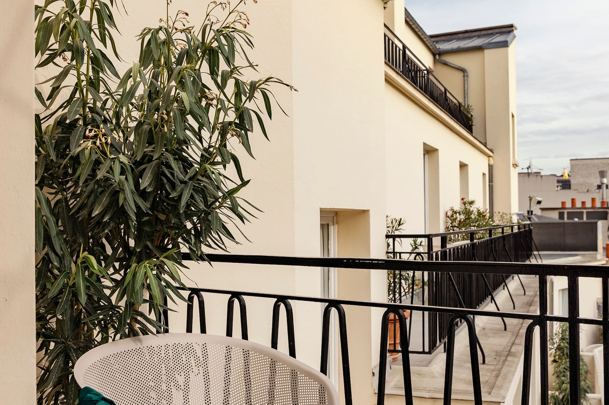 a chair and table on a balcony