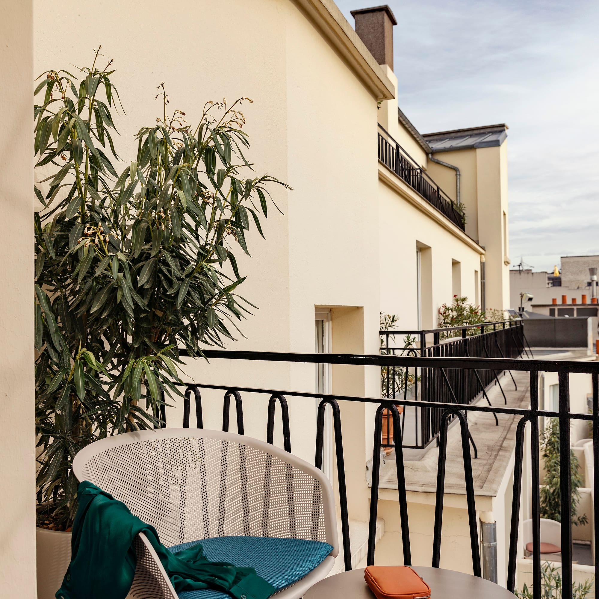 a chair and table on a balcony