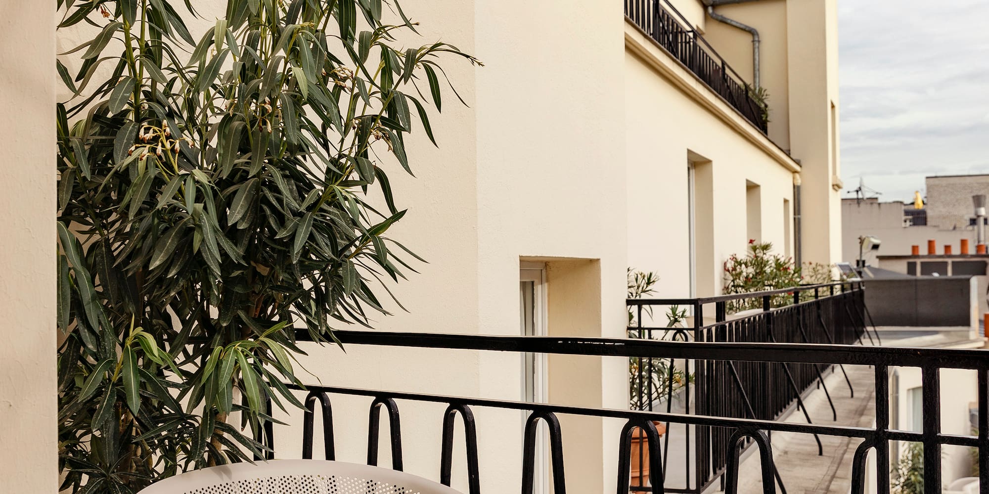 a chair and table on a balcony
