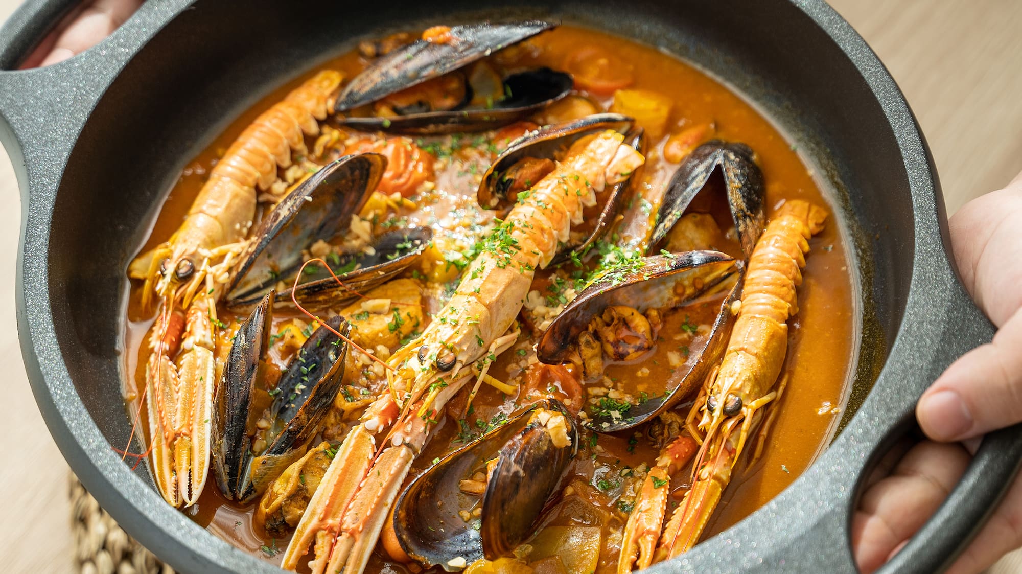 a person holding a bowl of soup