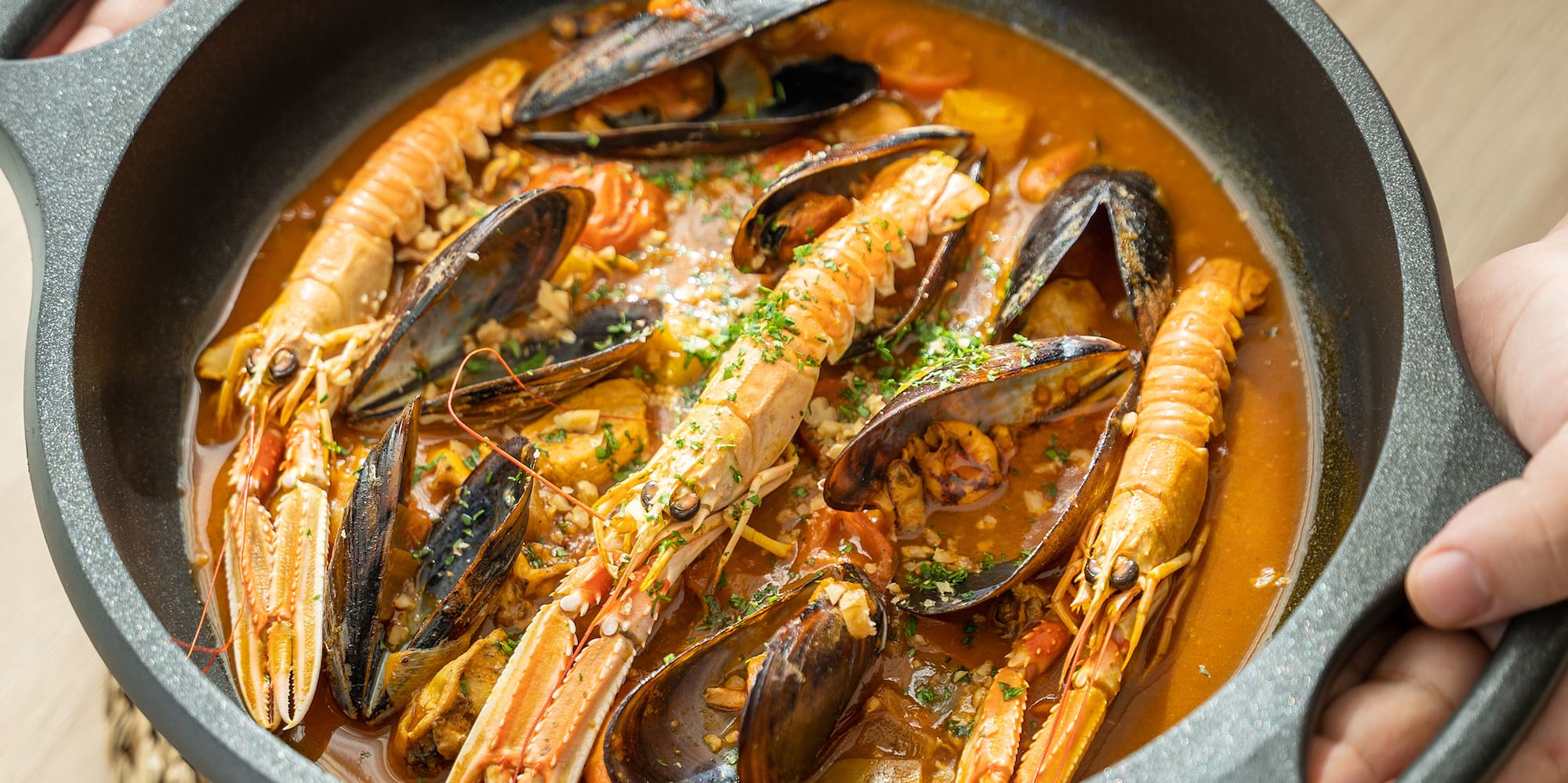 a person holding a bowl of soup