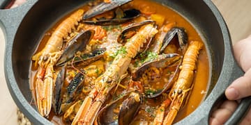 a person holding a bowl of soup