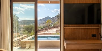 a room with a sliding glass door and a television