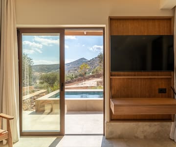 a room with a sliding glass door and a television