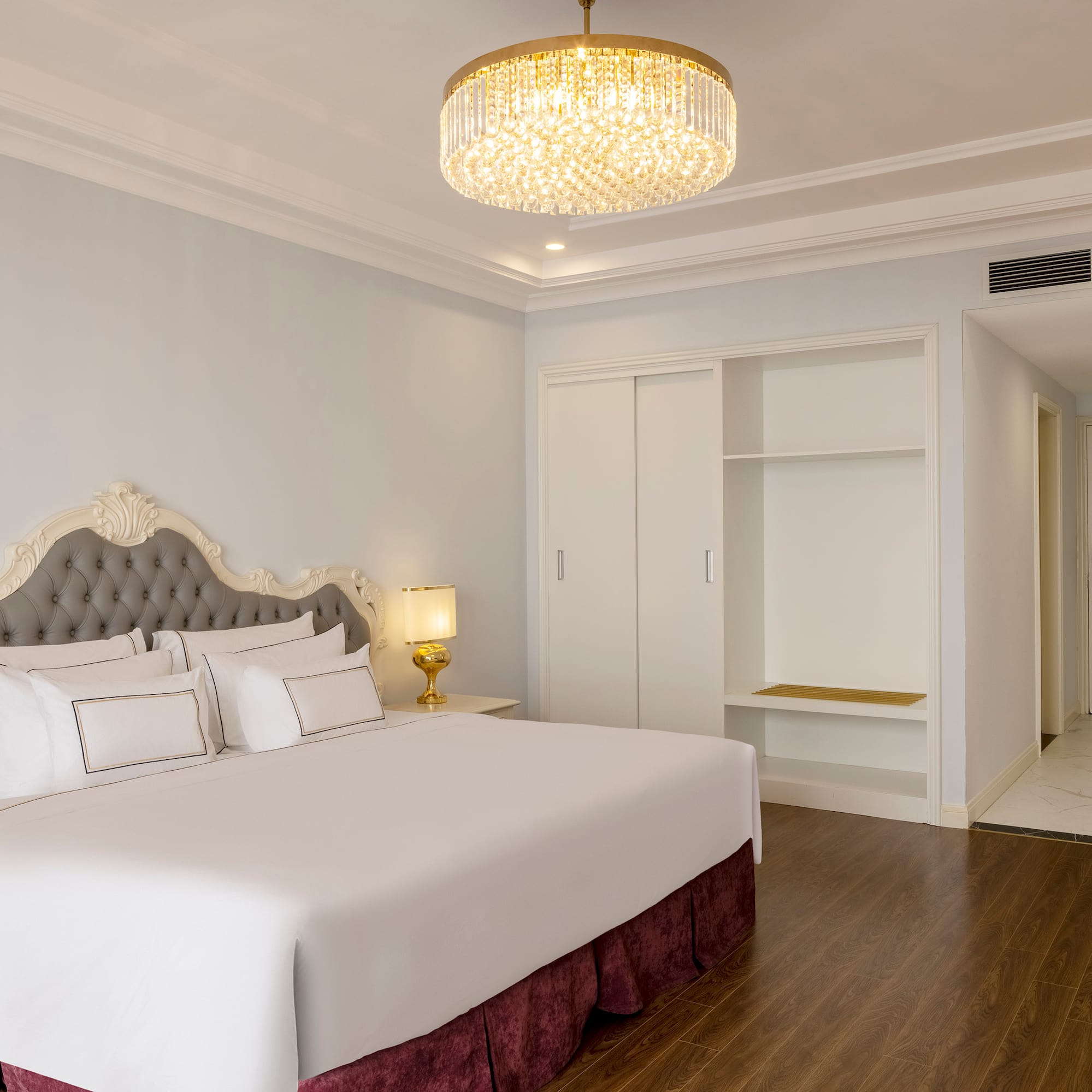 a bedroom with a chandelier and a bed