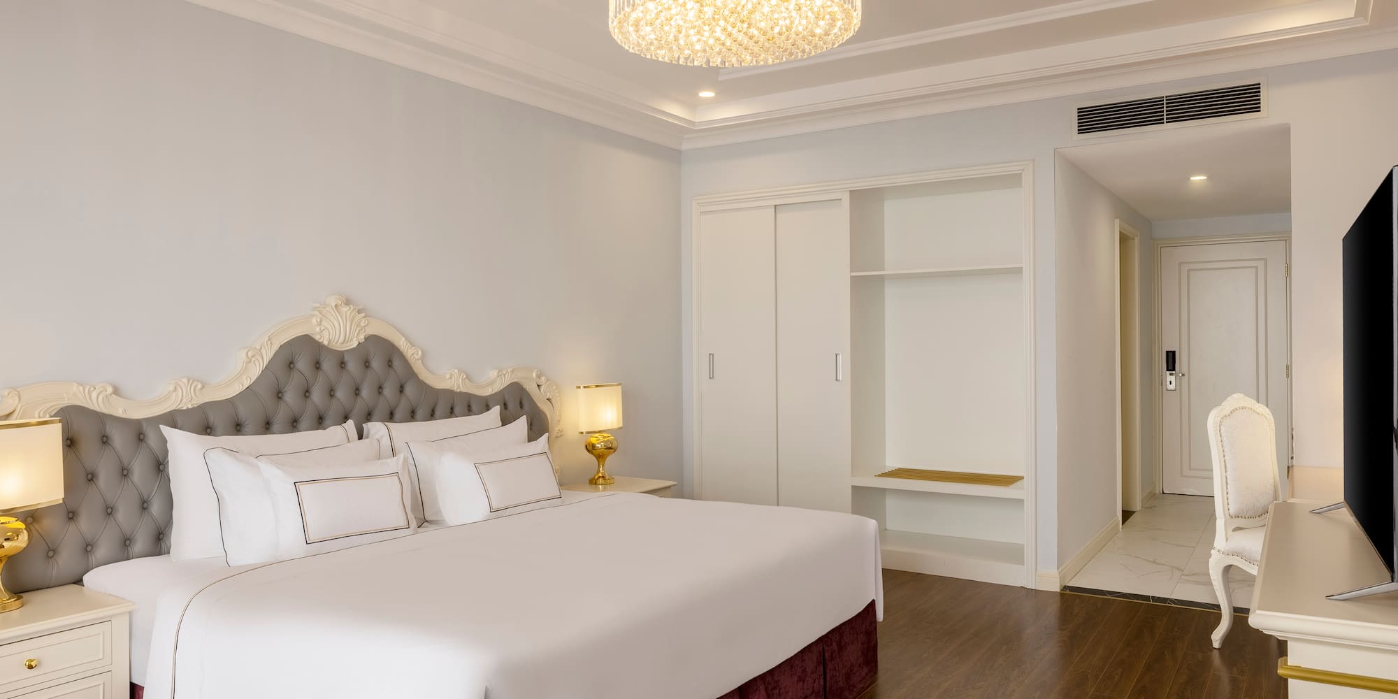 a bedroom with a chandelier and a bed