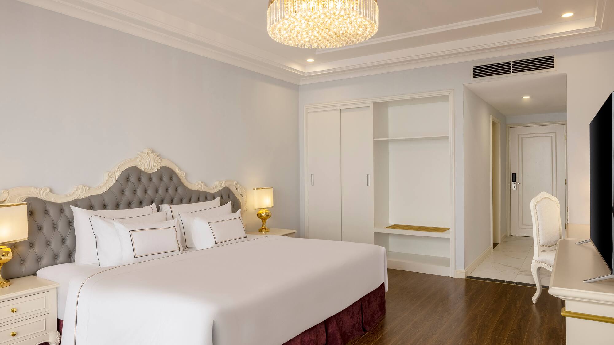 a bedroom with a chandelier and a bed