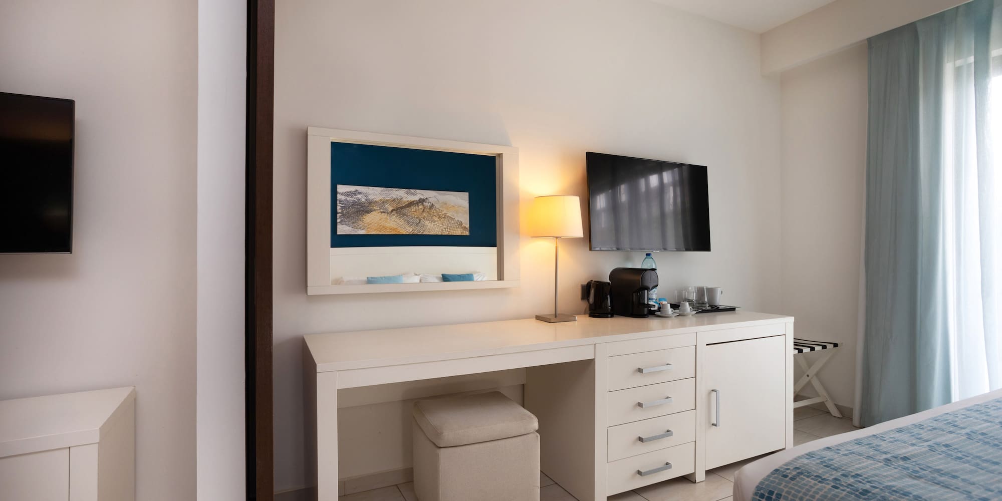 a room with a desk and a television