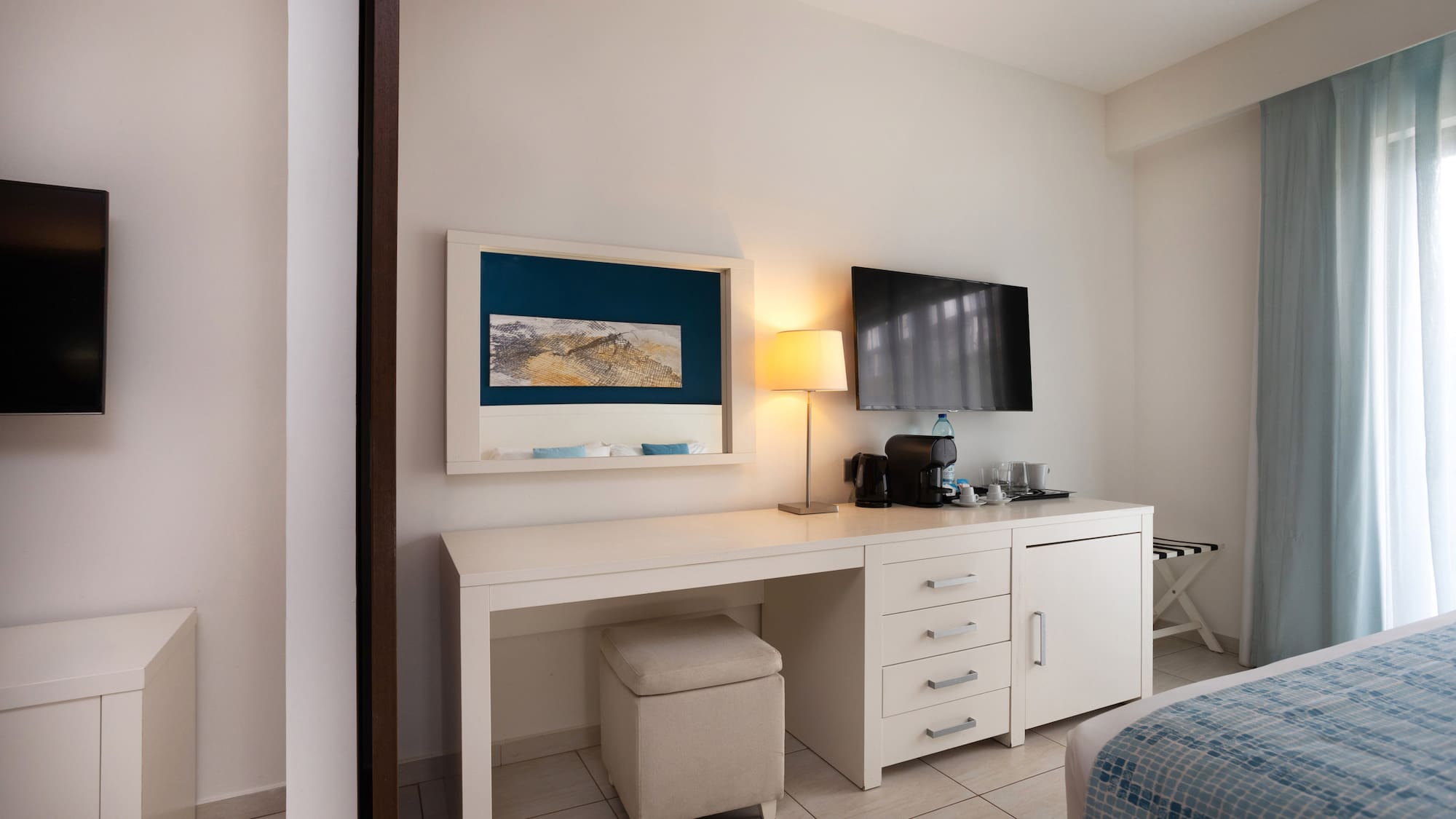 a room with a desk and a television