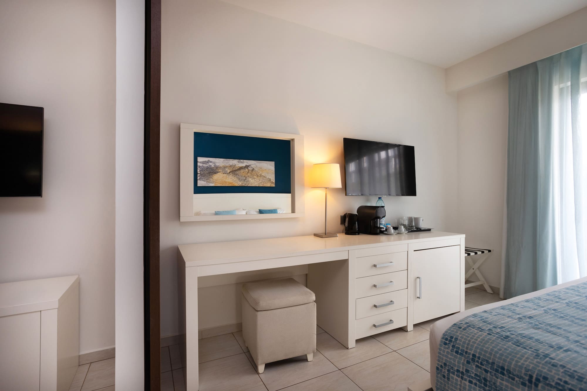 a room with a desk and a television