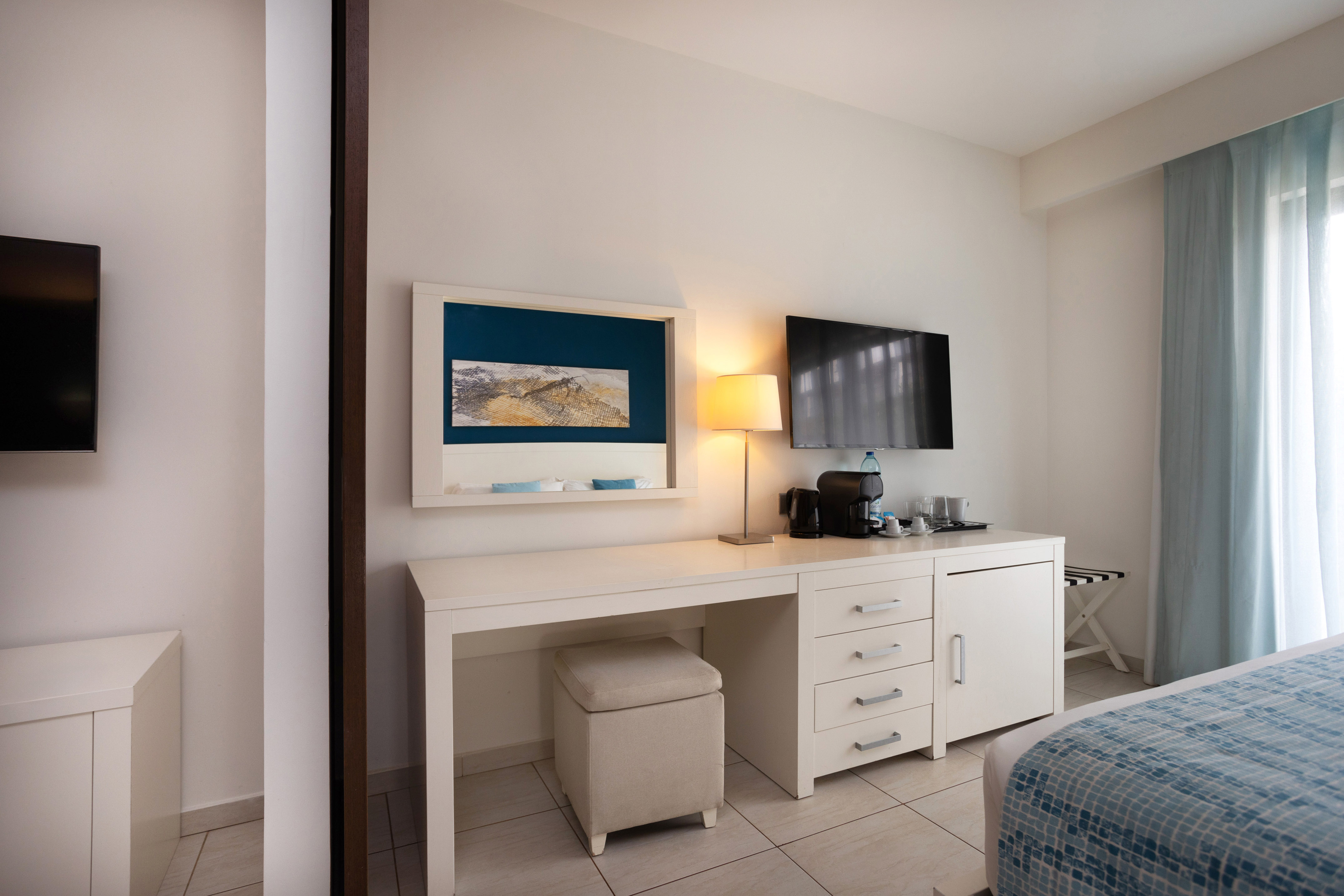 a room with a desk and a television