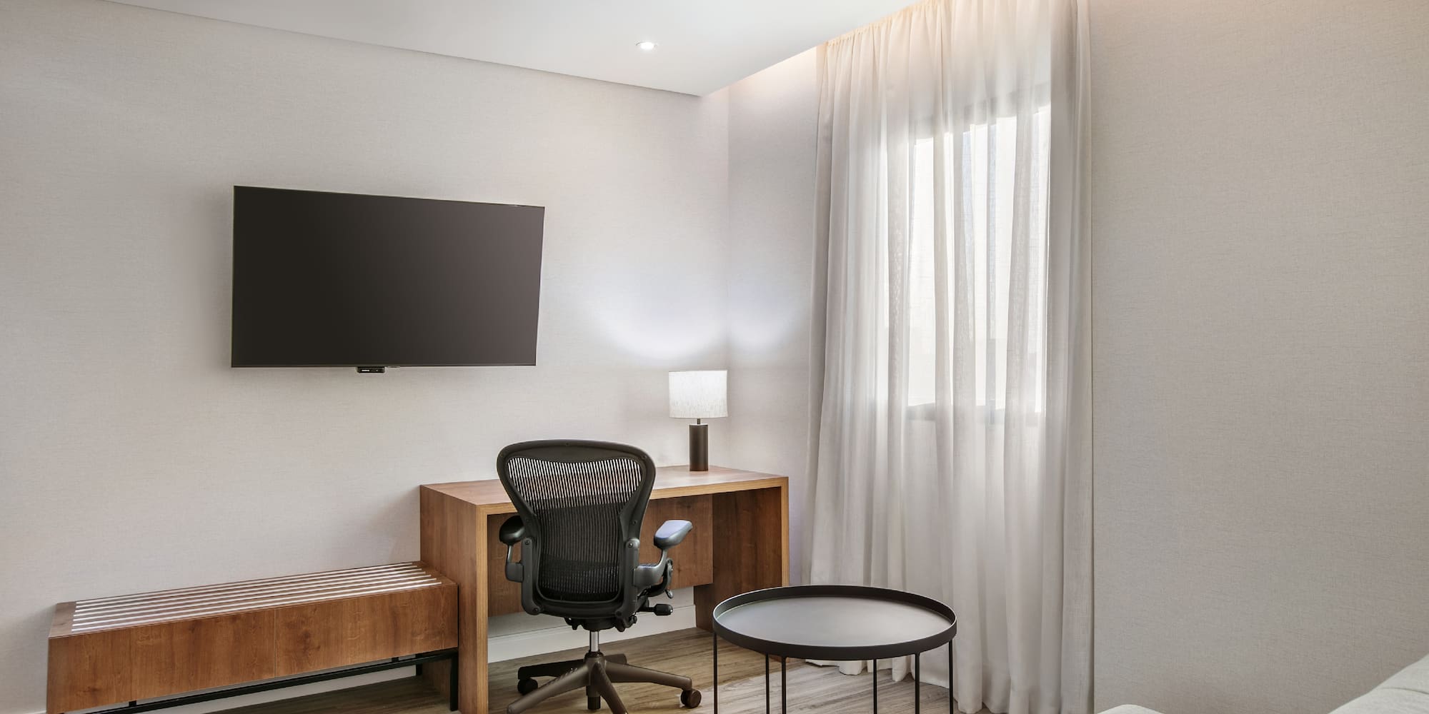 a room with a desk and a tv