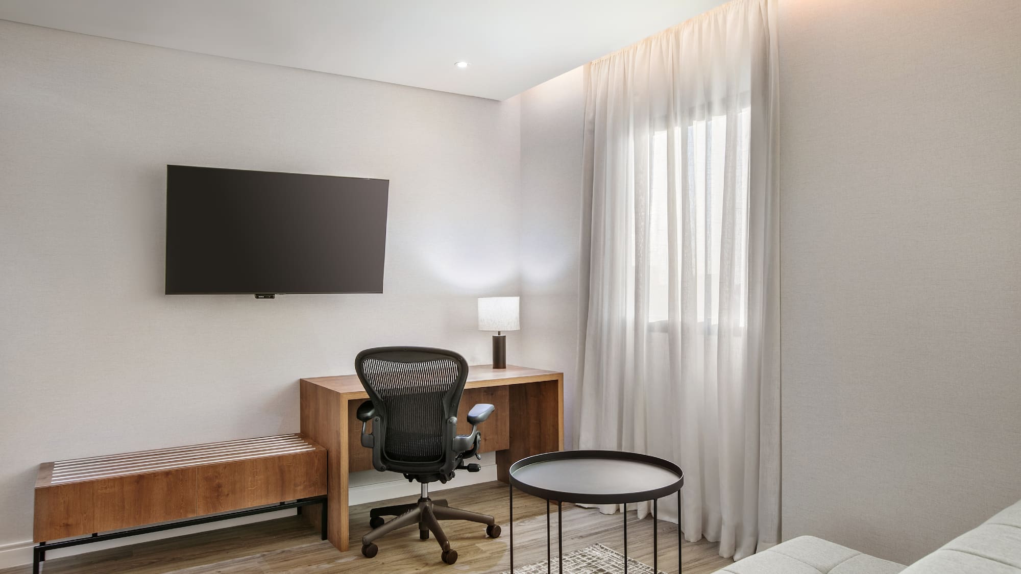 a room with a desk and a tv