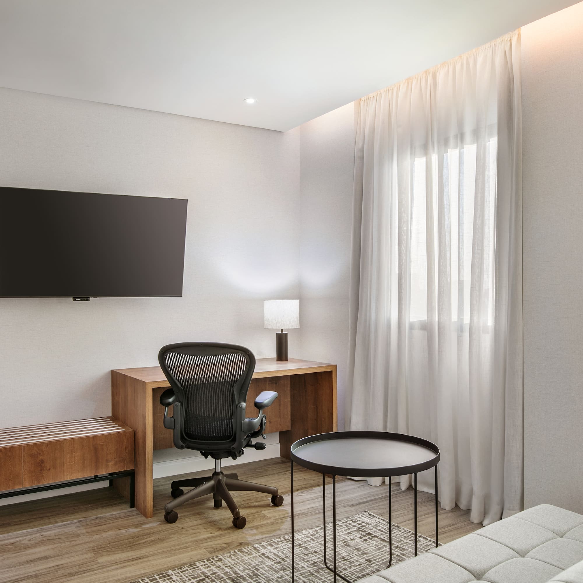 a room with a desk and a tv