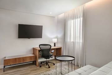 a room with a desk and a tv