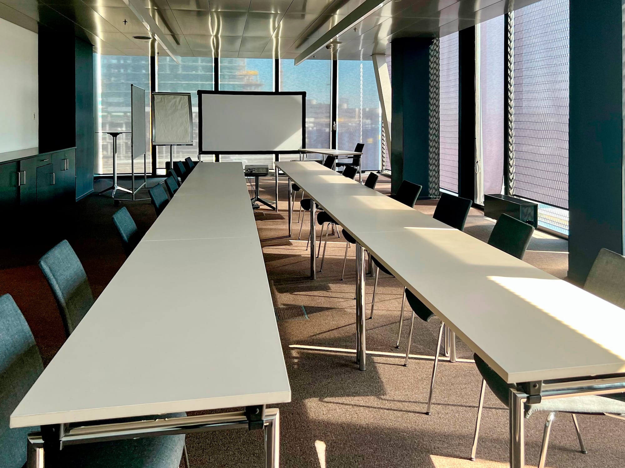 a room with long tables and chairs