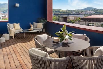 a patio with a table and chairs