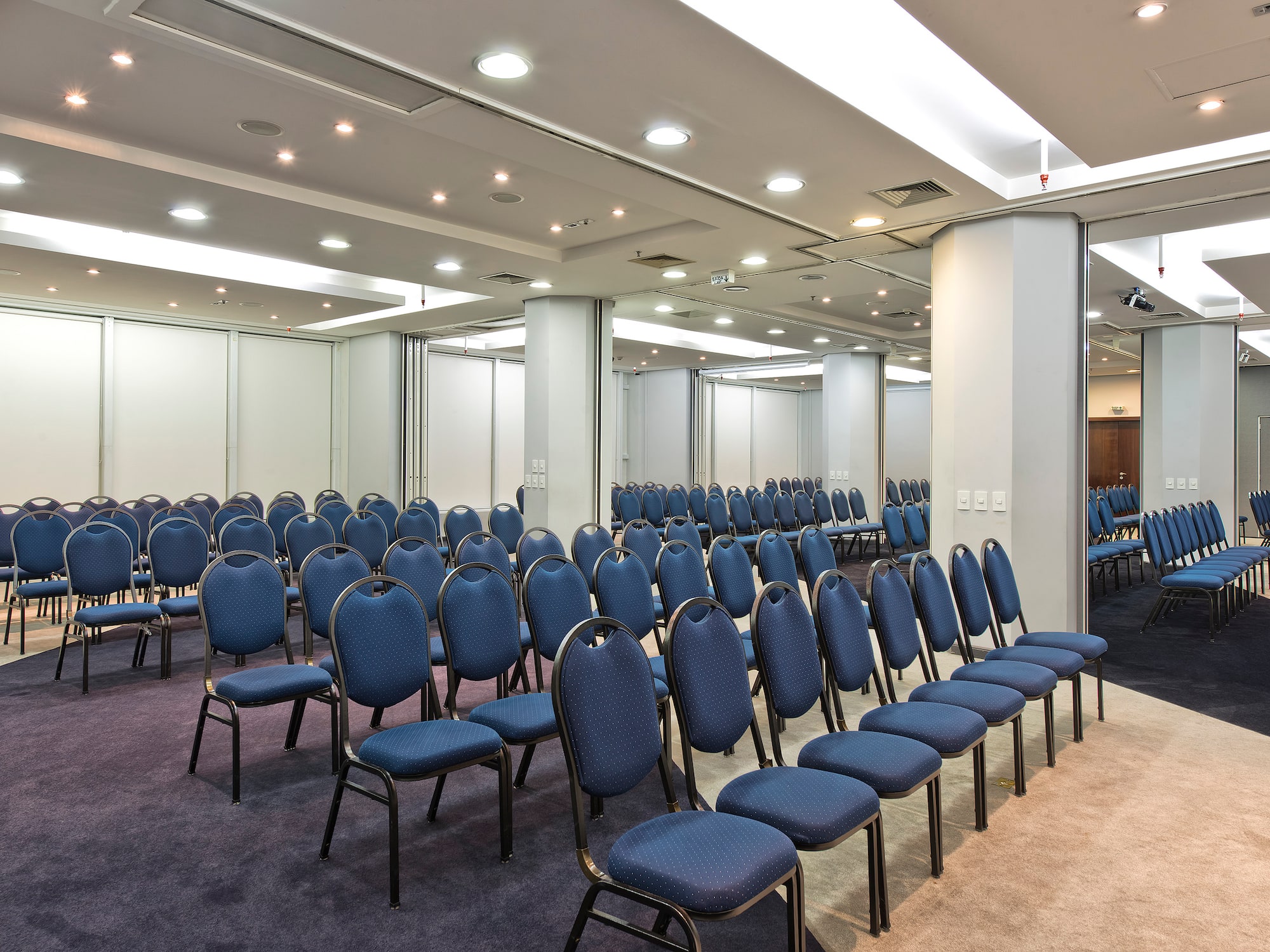 a room with rows of blue chairs