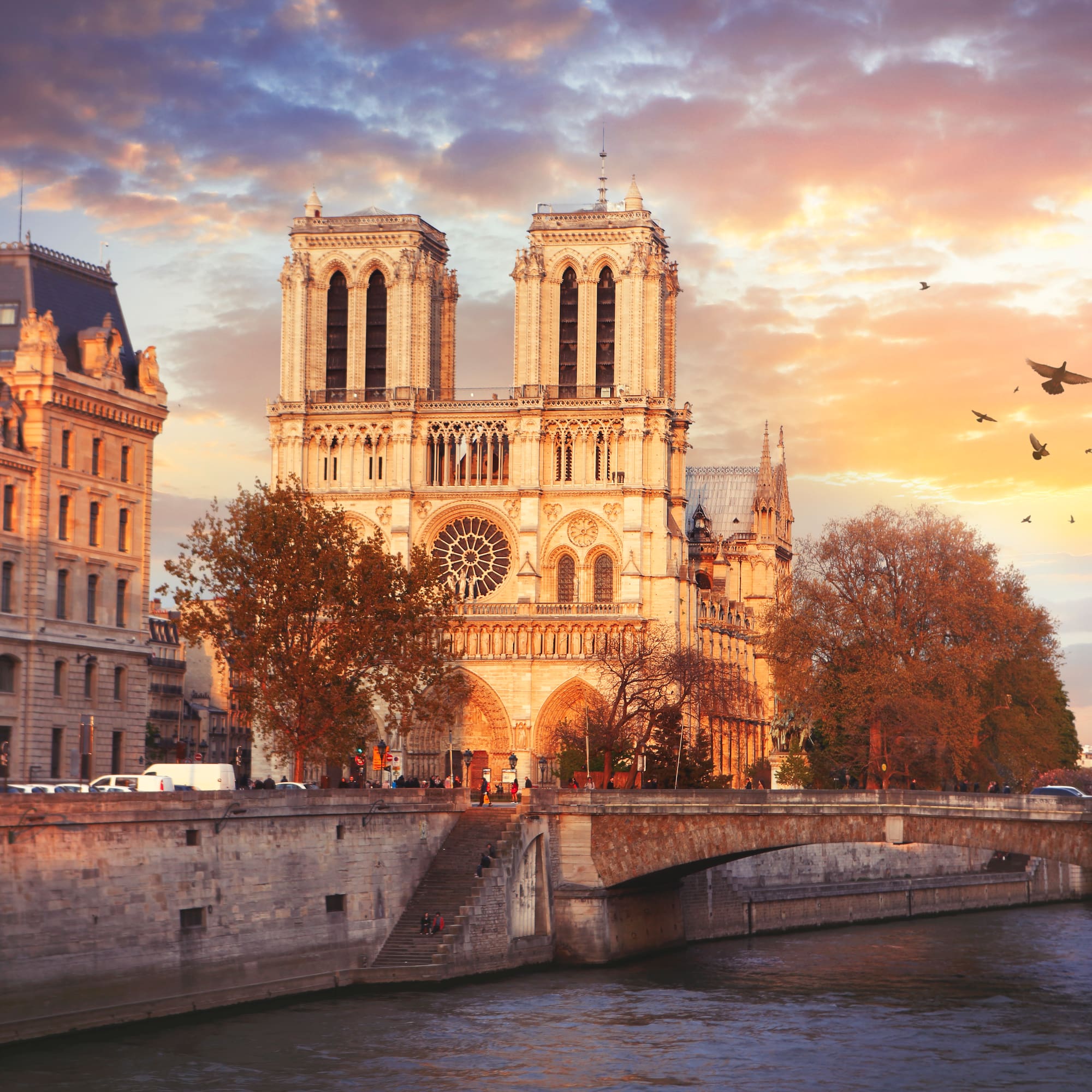 a building with towers and a bridge over a river