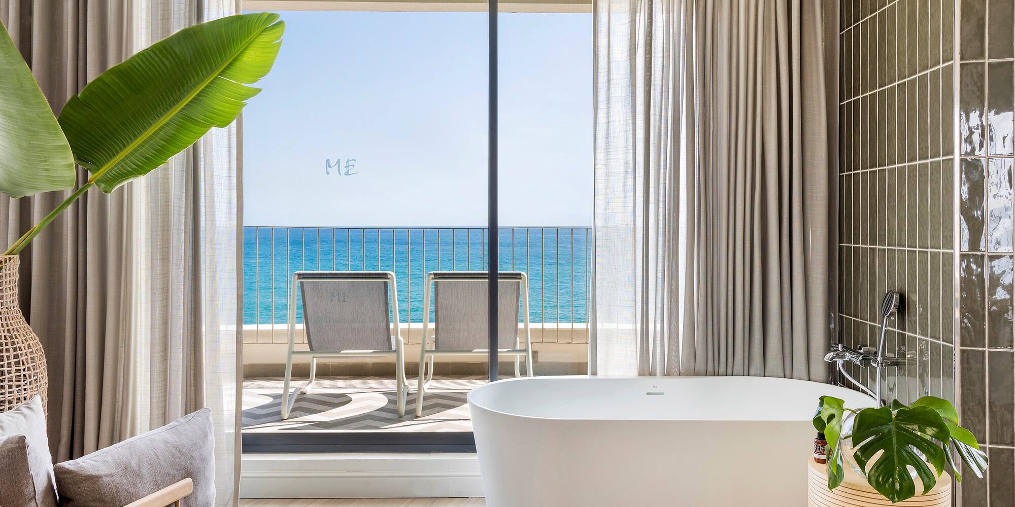 a bathroom with a tub and a large window