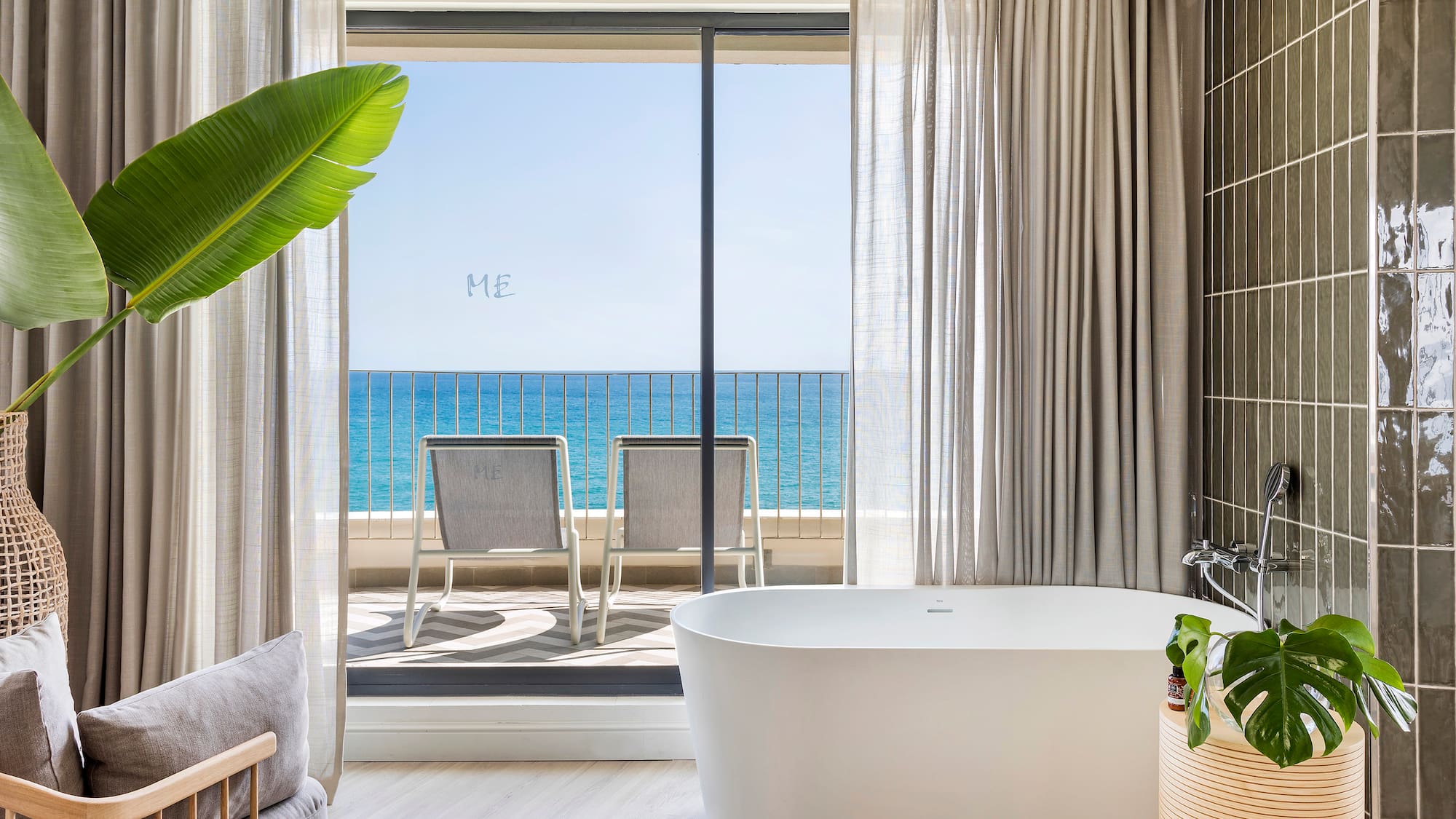 a bathroom with a tub and a large window