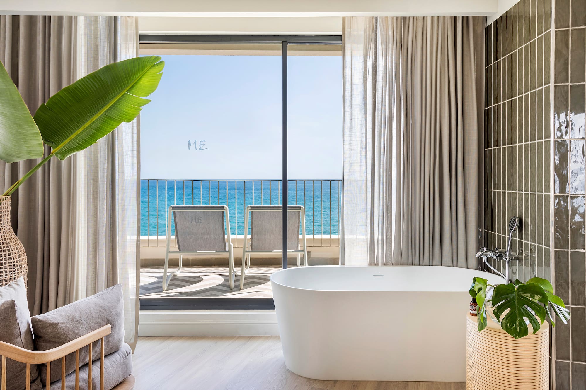 a bathroom with a tub and a large window