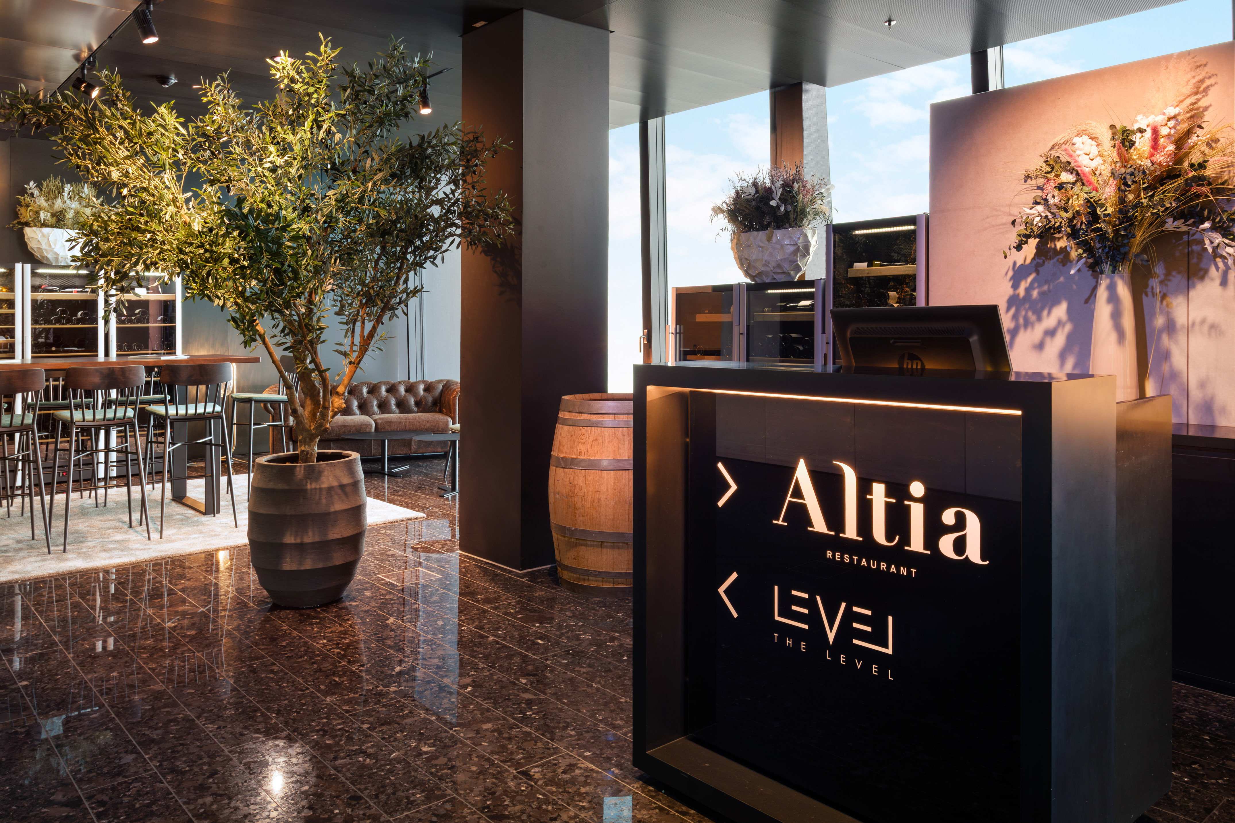Altia Restaurant and Level reception with modern bar and olive tree.