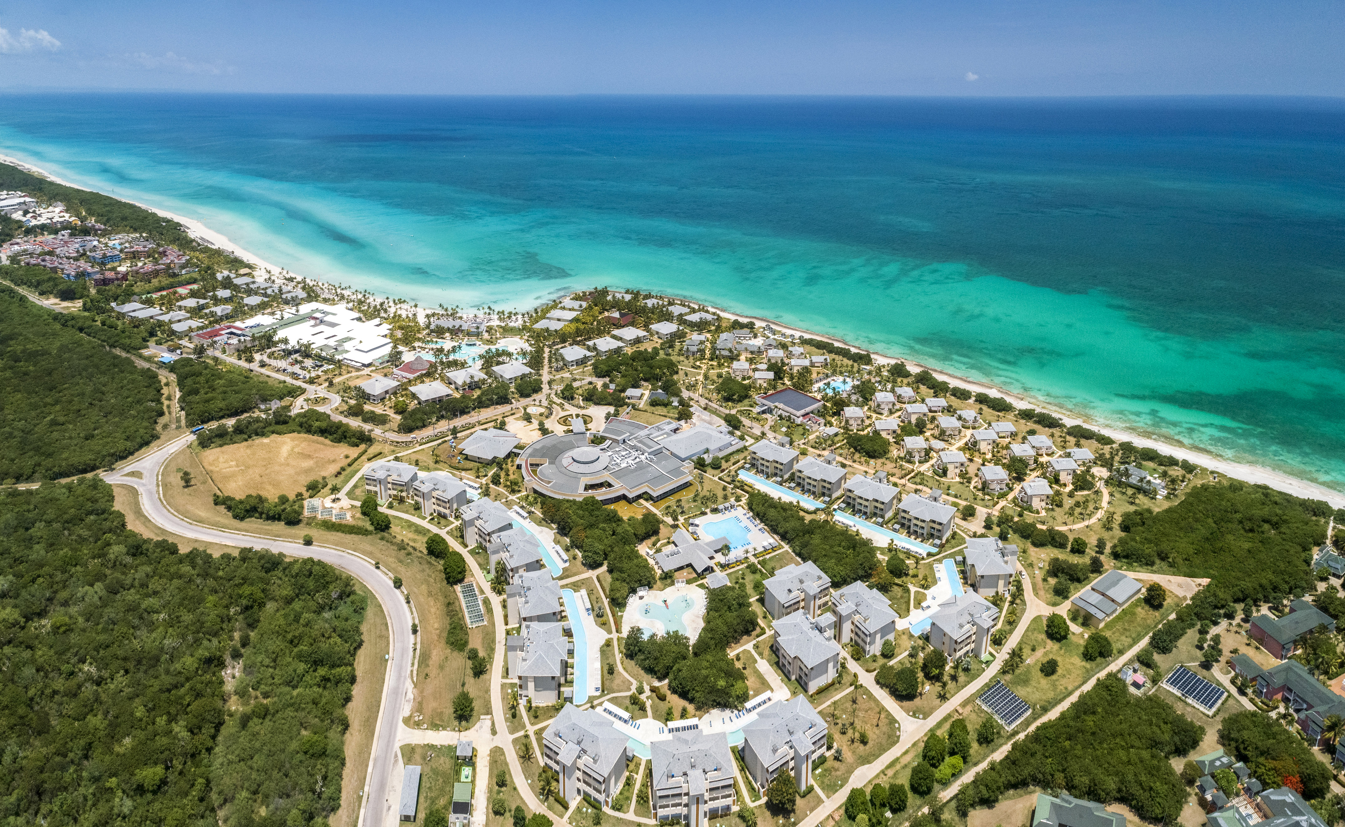 a aerial view of a beach with buildings and trees