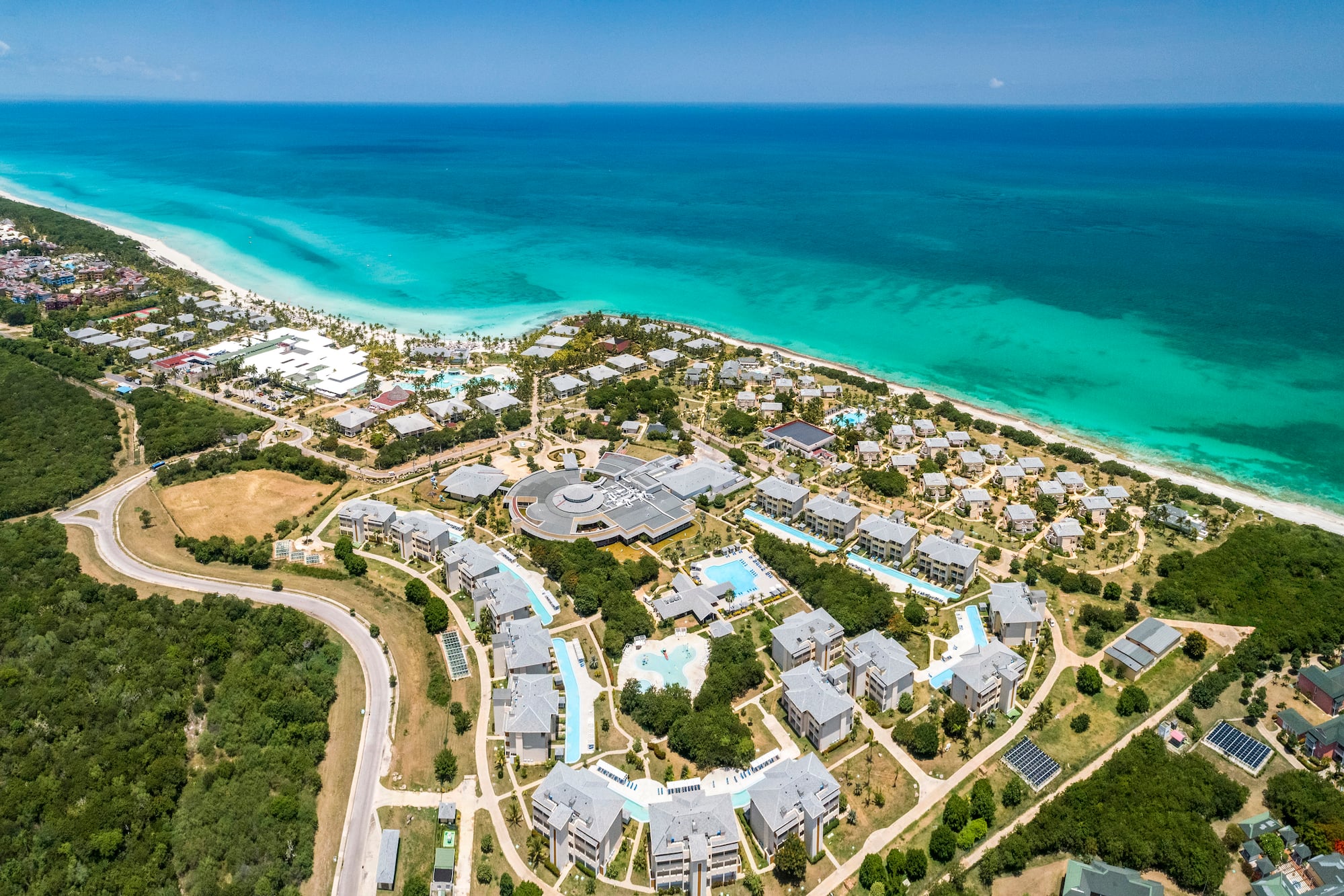 a aerial view of a beach with buildings and trees