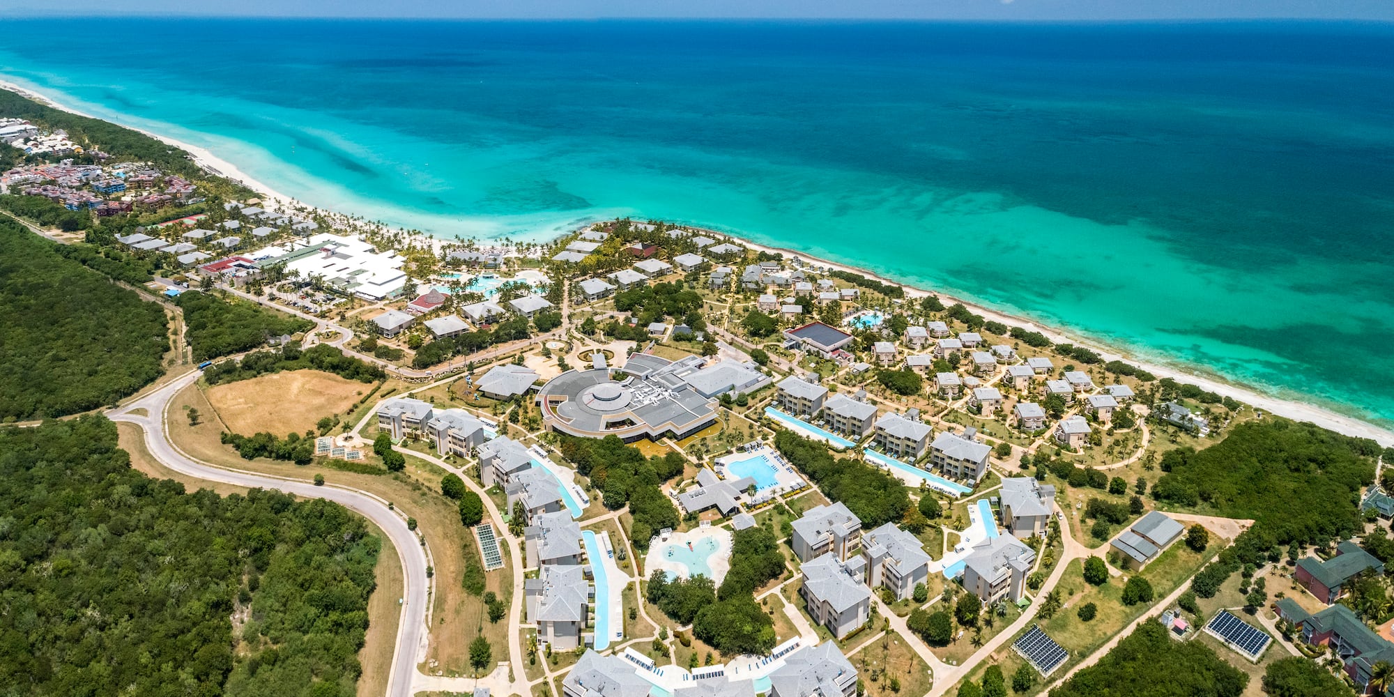a aerial view of a beach with buildings and trees