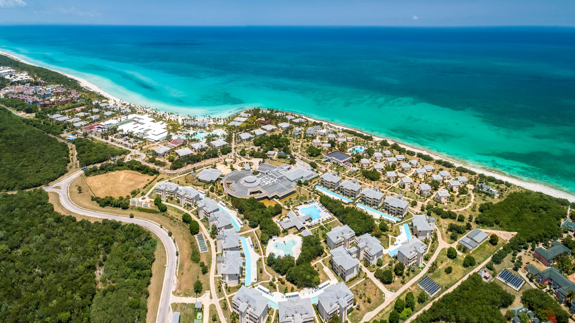 a aerial view of a beach with buildings and trees