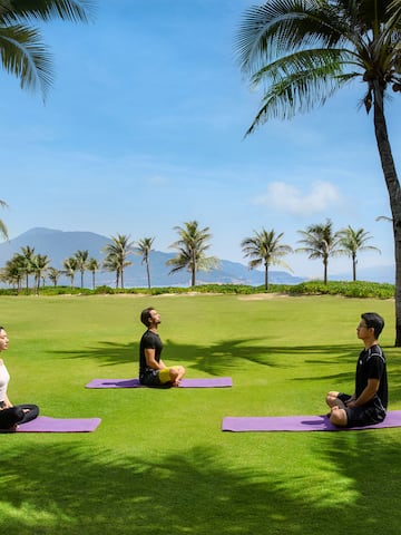 people sitting on mats in a park.