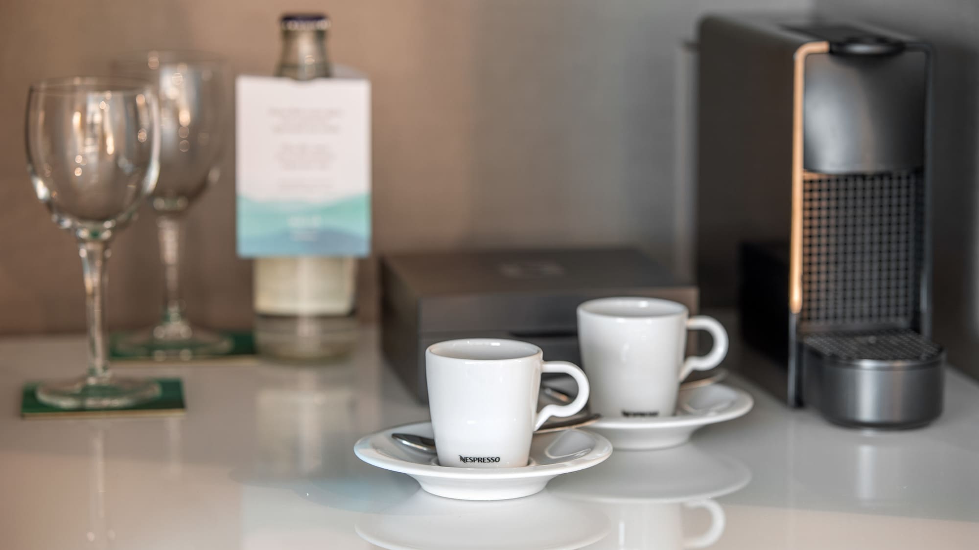 a couple of white cups on saucers on a table