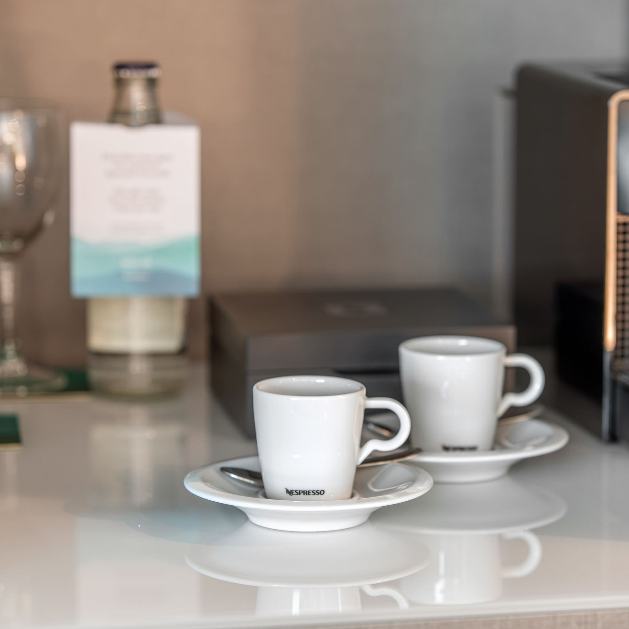 a couple of white cups on saucers on a table