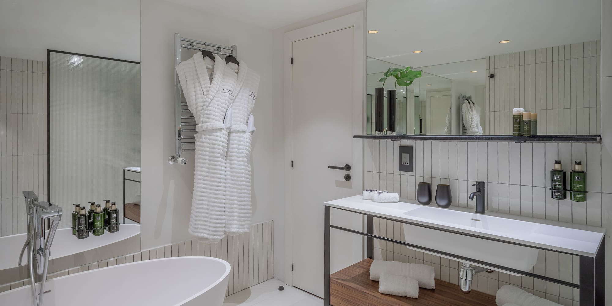 a bathroom with a bathrobe and a sink