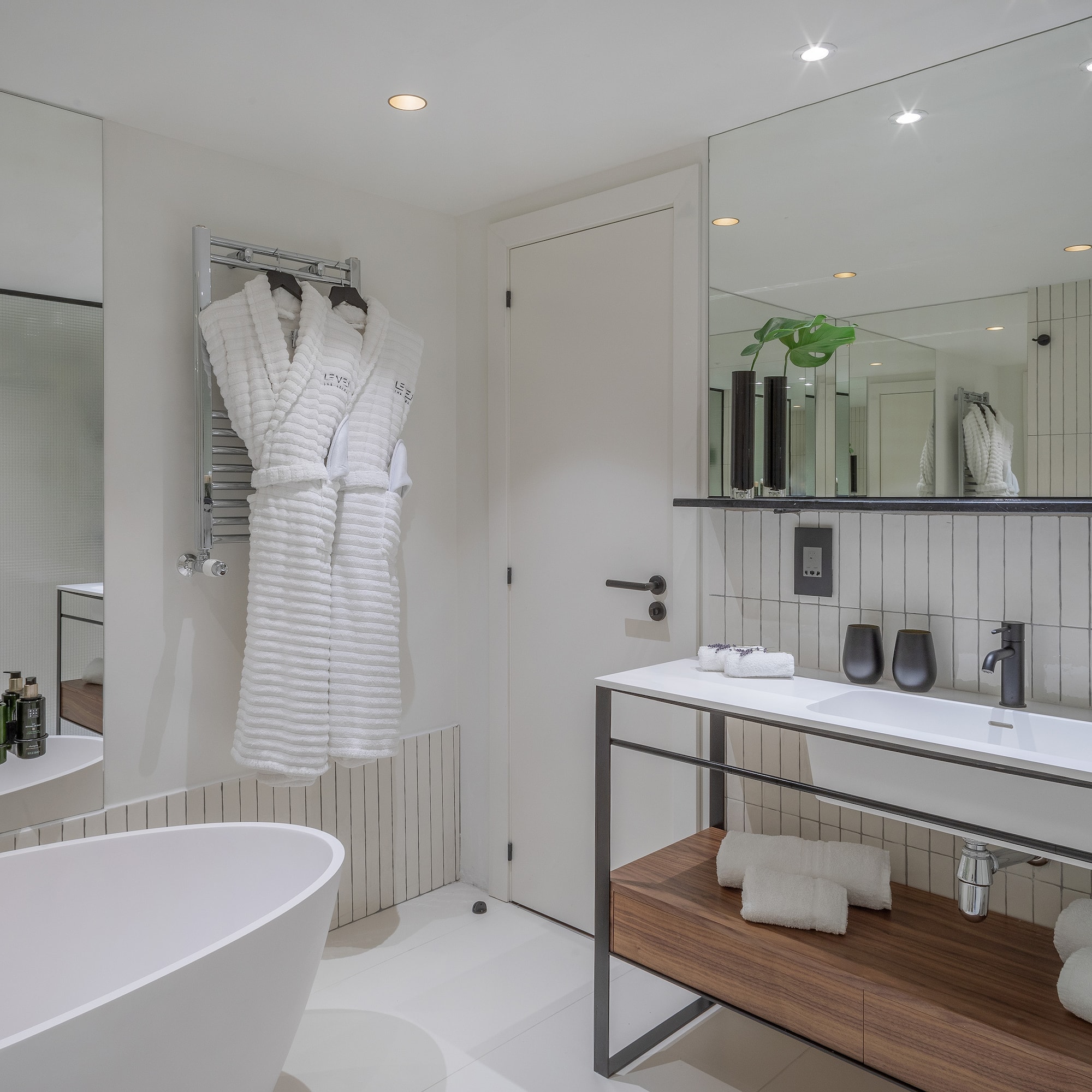 a bathroom with a bathrobe and a sink