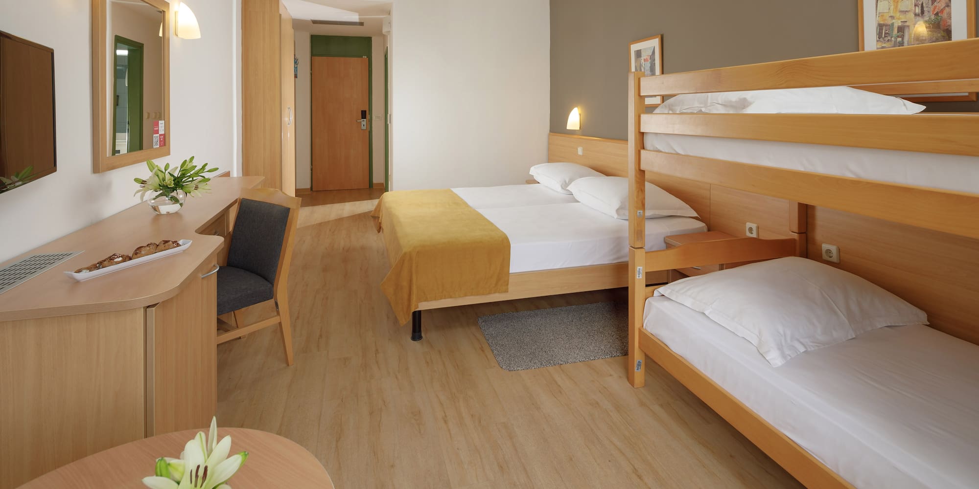 a room with bunk beds and a desk