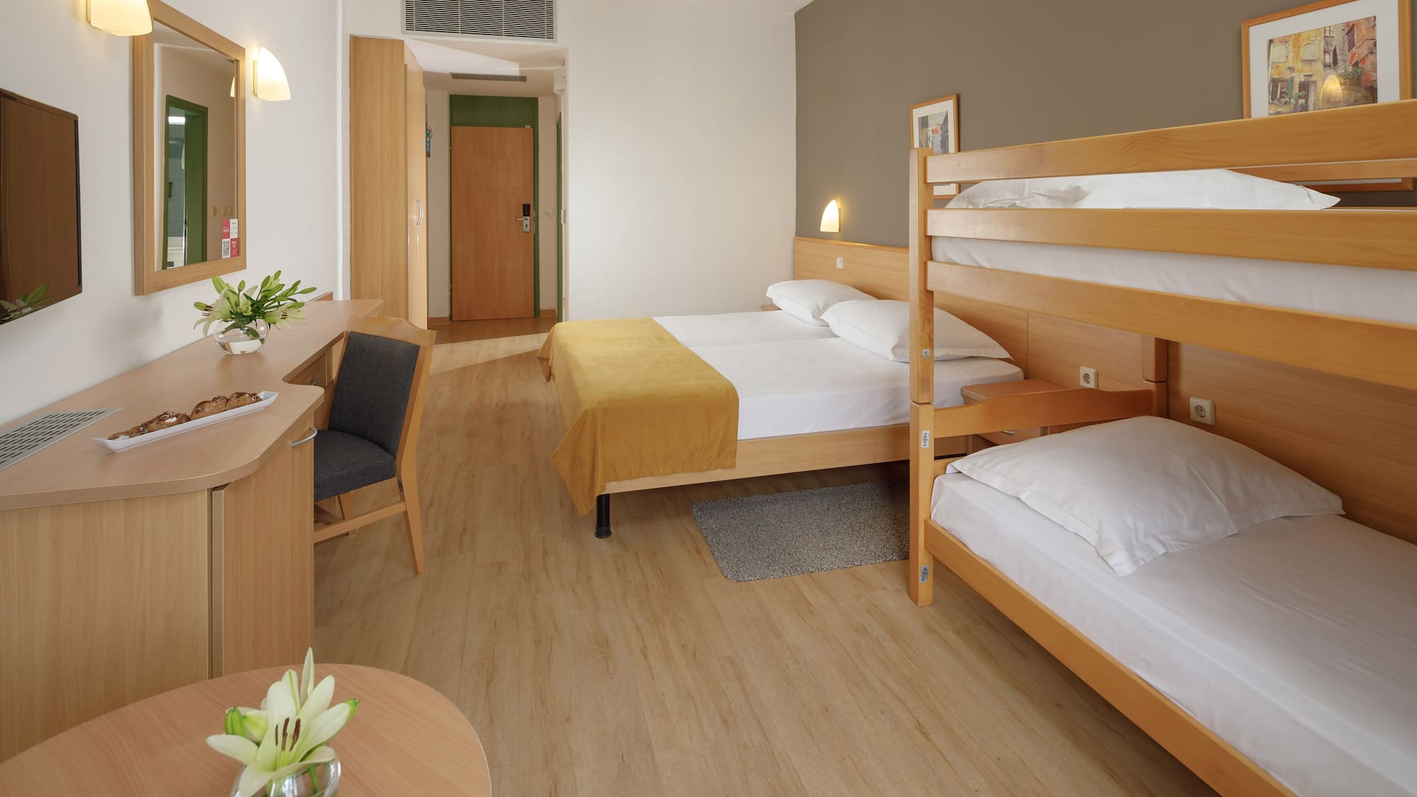 a room with bunk beds and a desk