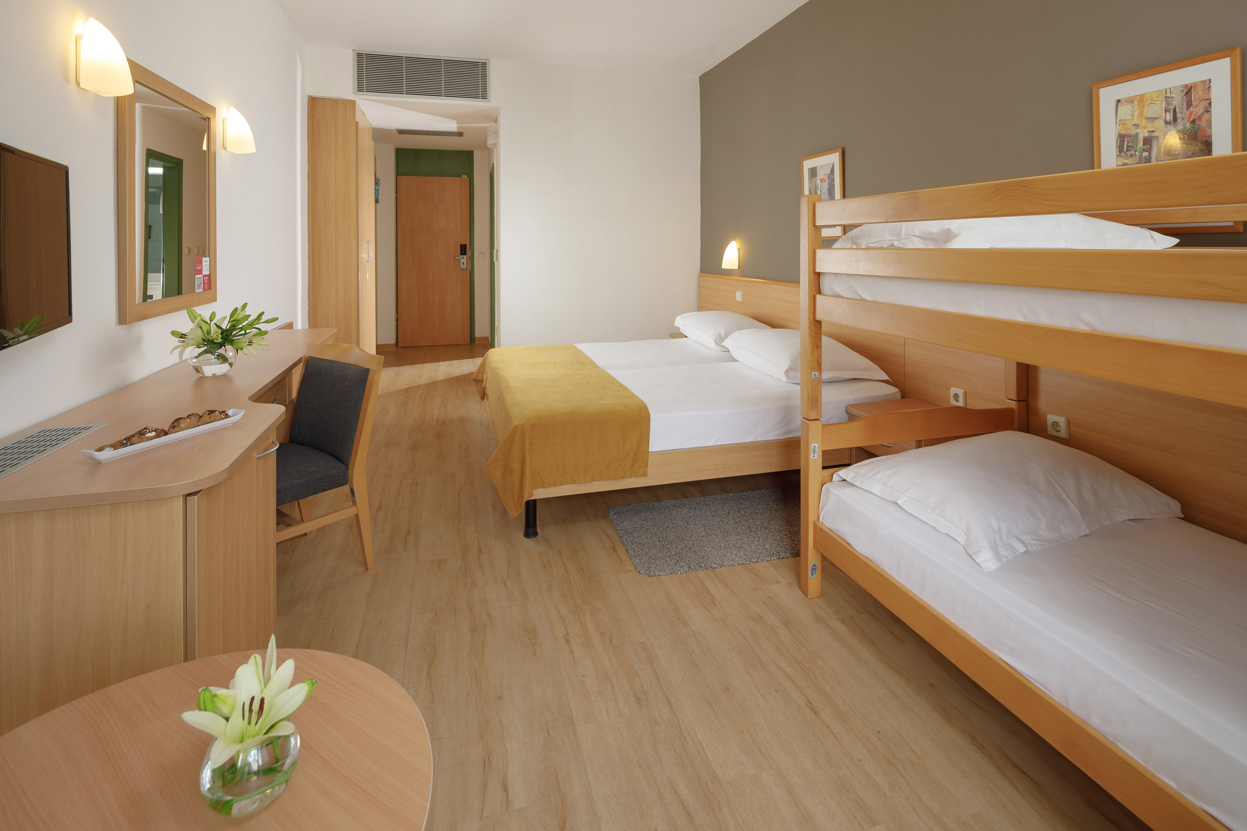 a room with bunk beds and a desk