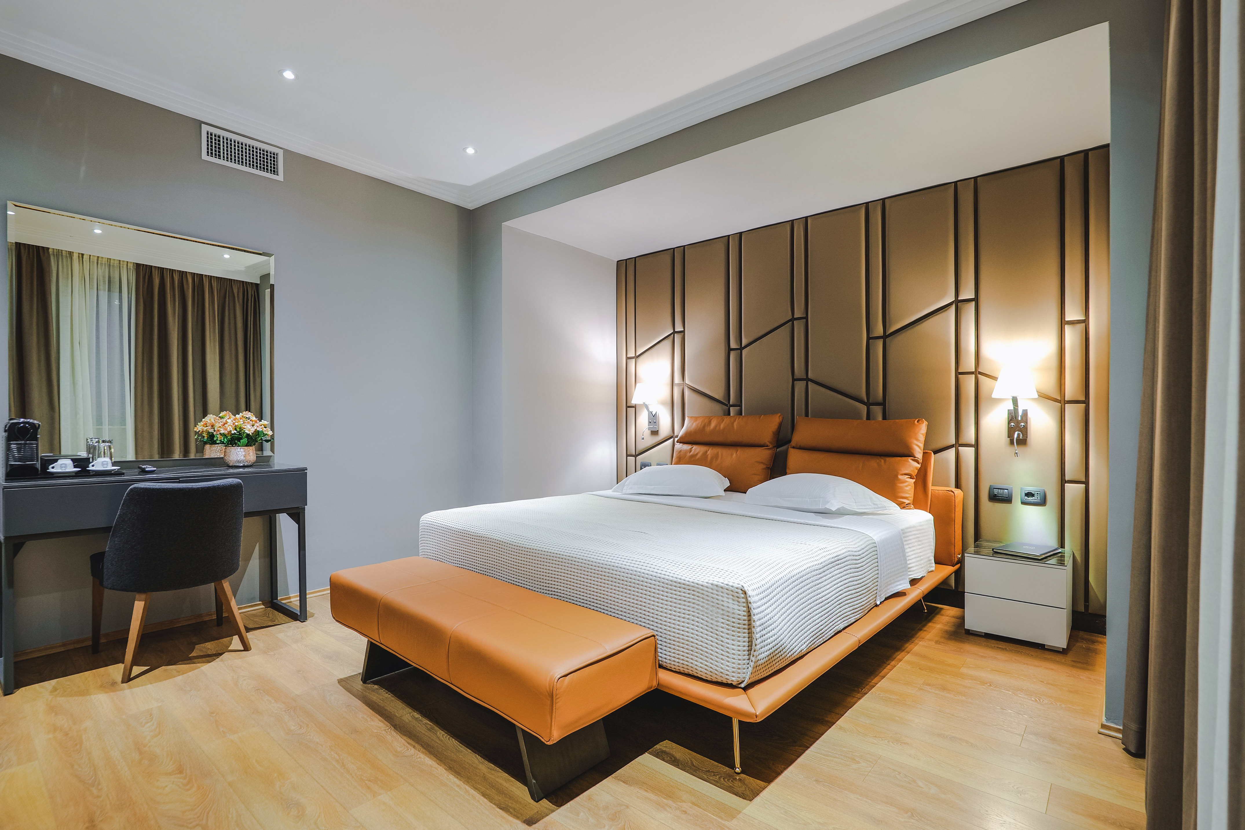 a bedroom with a bed and a mirror
