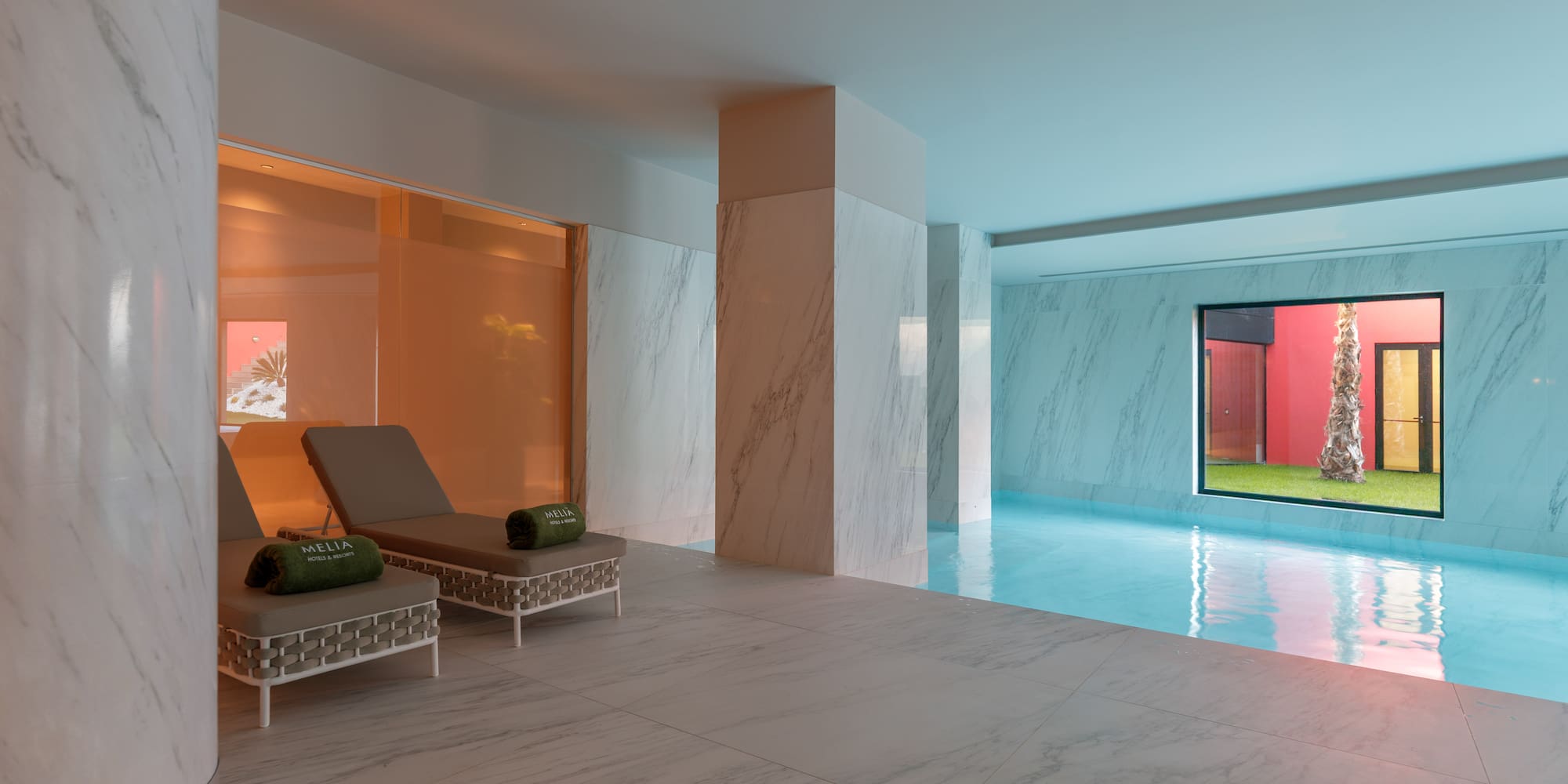 a pool with chairs and a large window