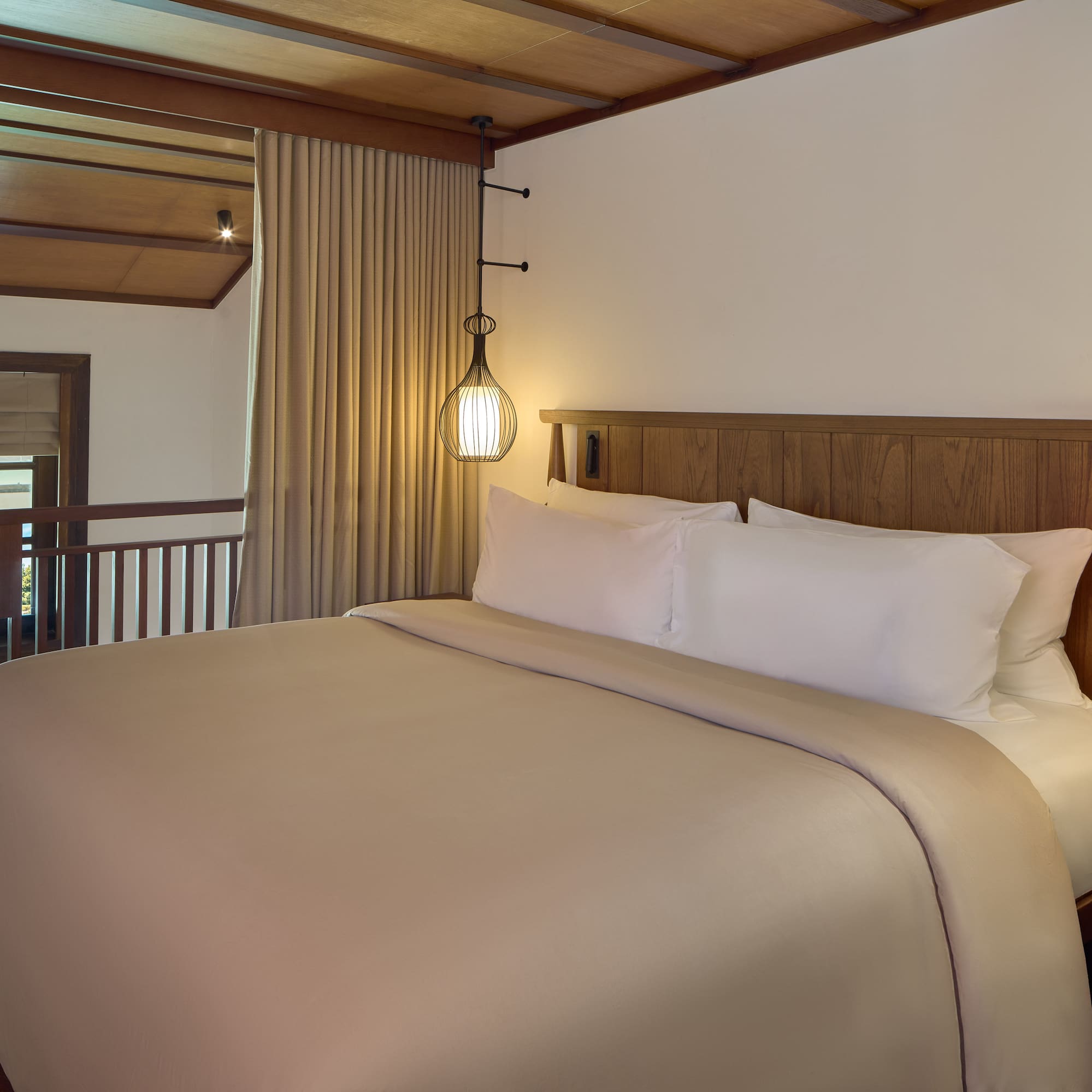 a bed with a wooden headboard and a lamp