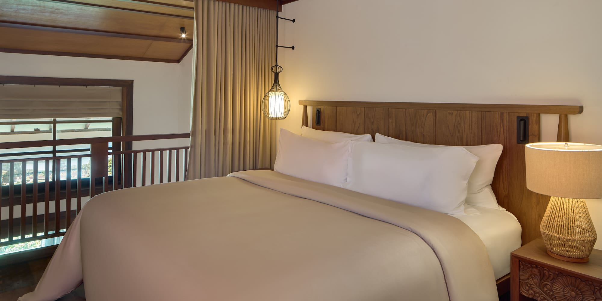 a bed with a wooden headboard and a lamp