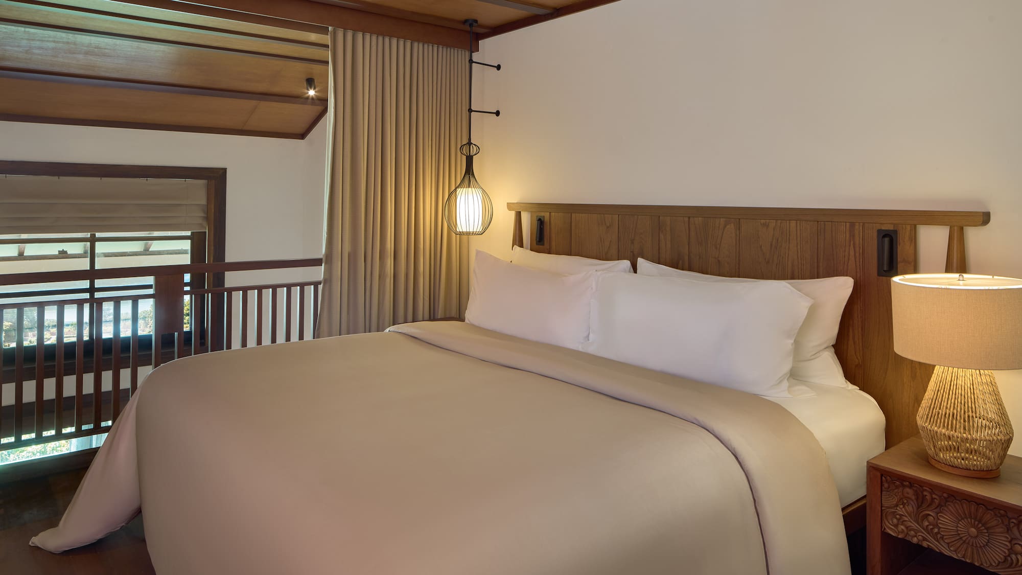 a bed with a wooden headboard and a lamp