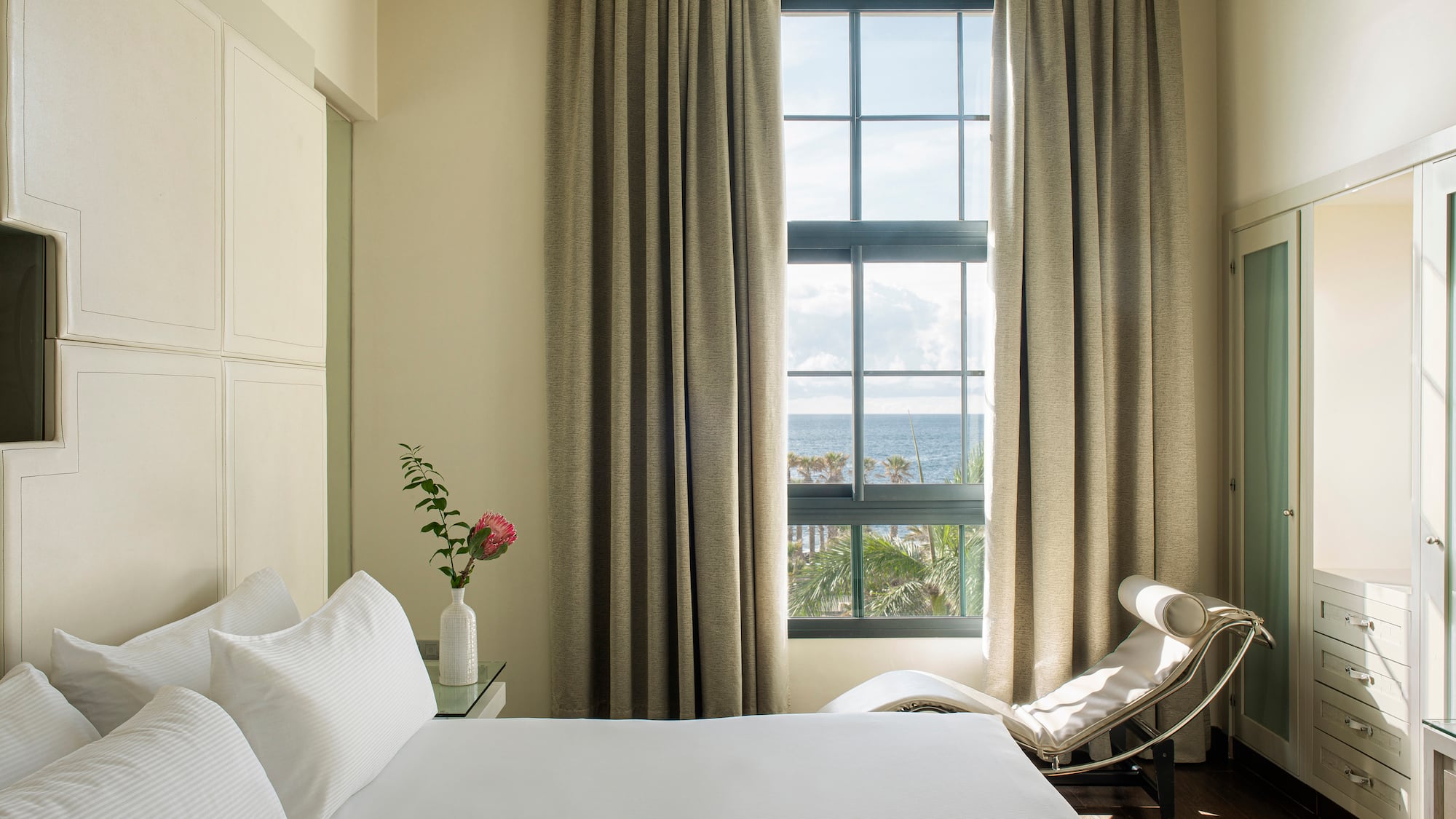 a bedroom with a bed and a chair