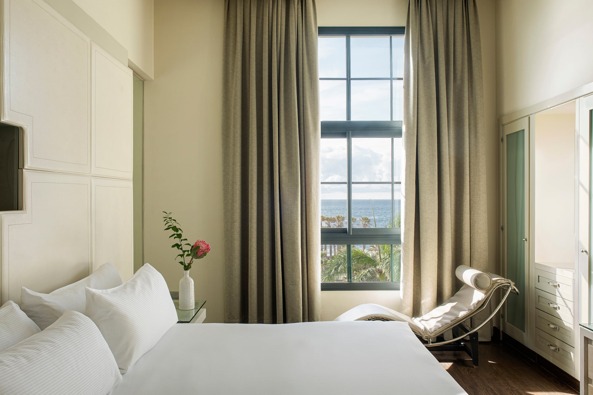 a bedroom with a bed and a chair