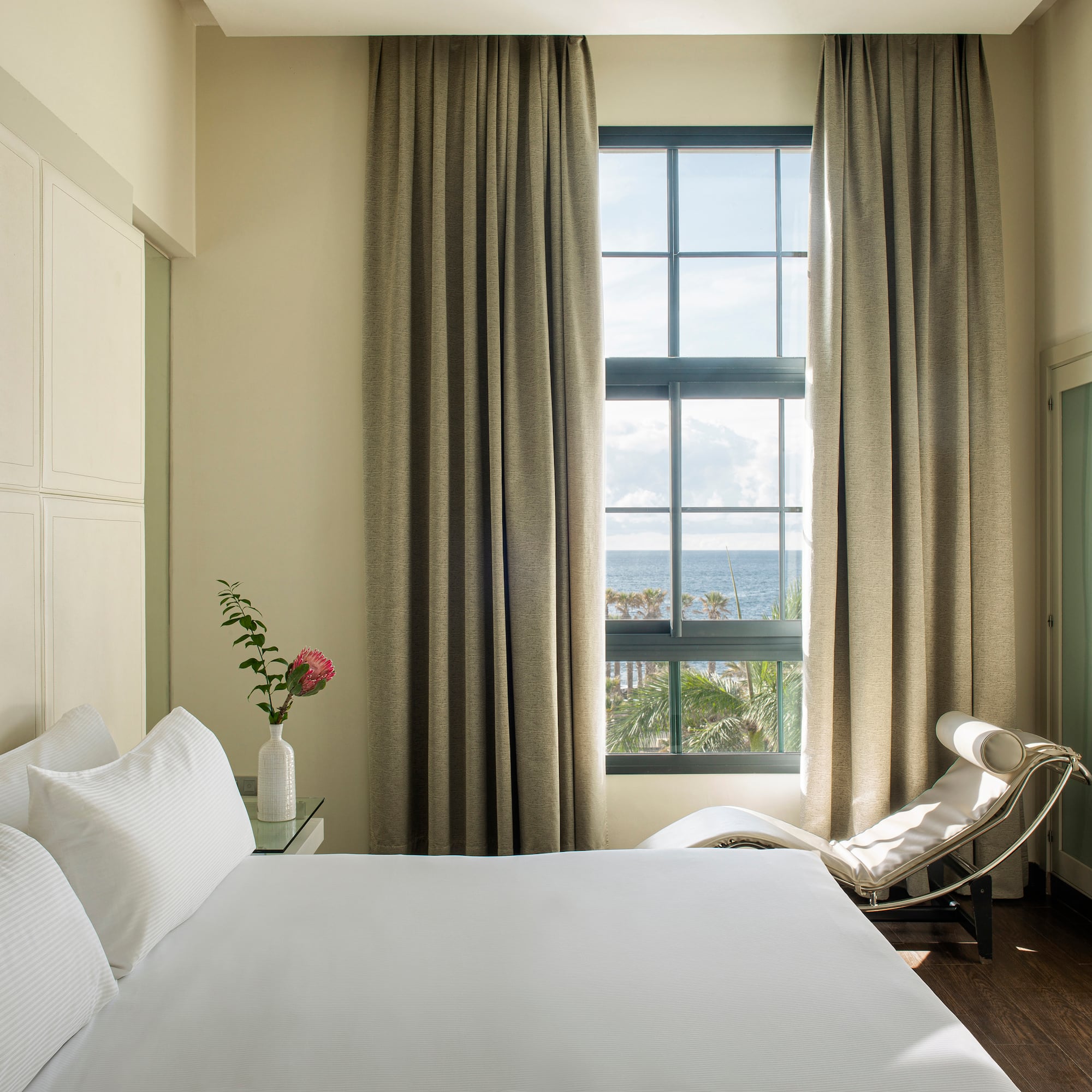 a bedroom with a bed and a chair