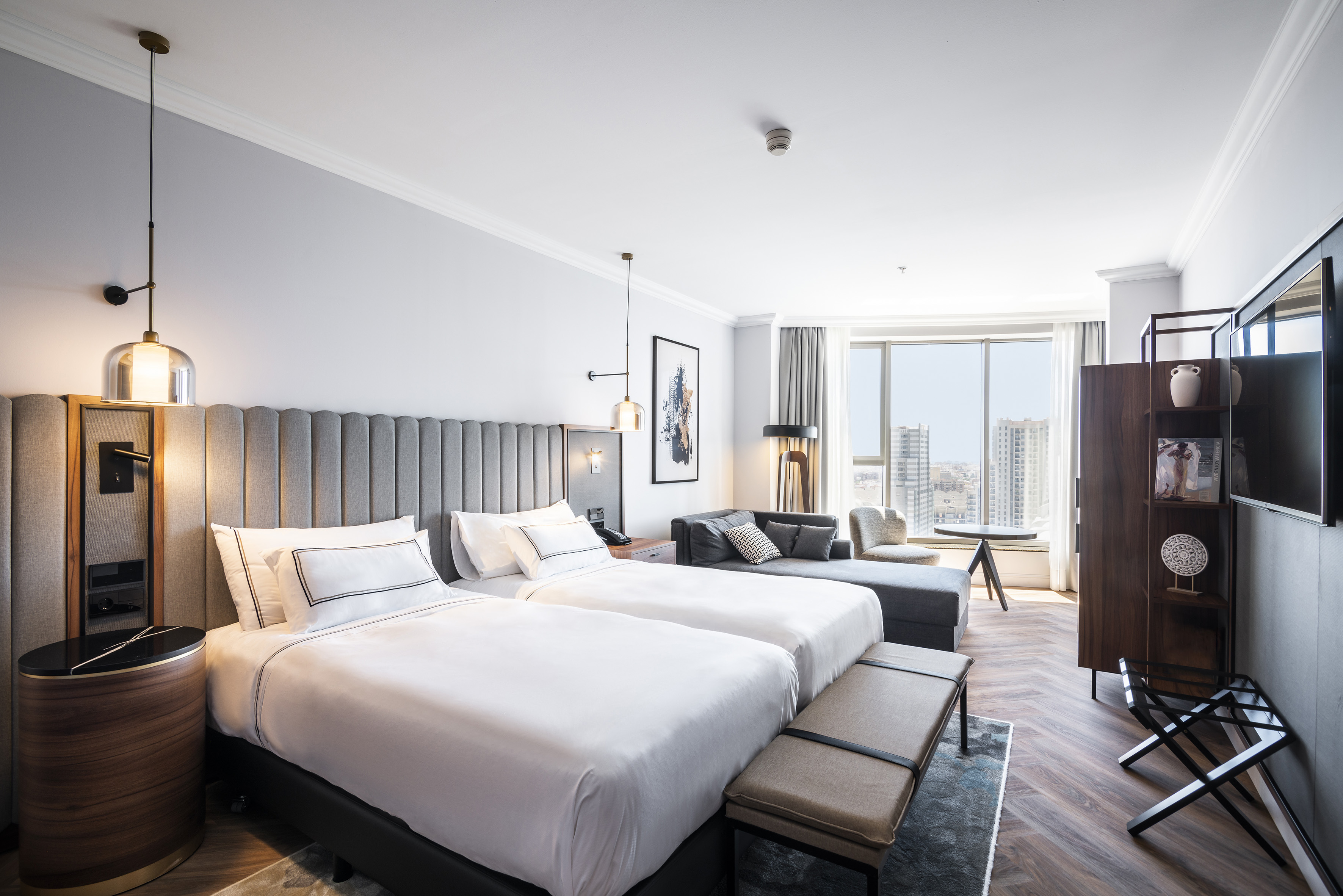 a room with two beds and a couch