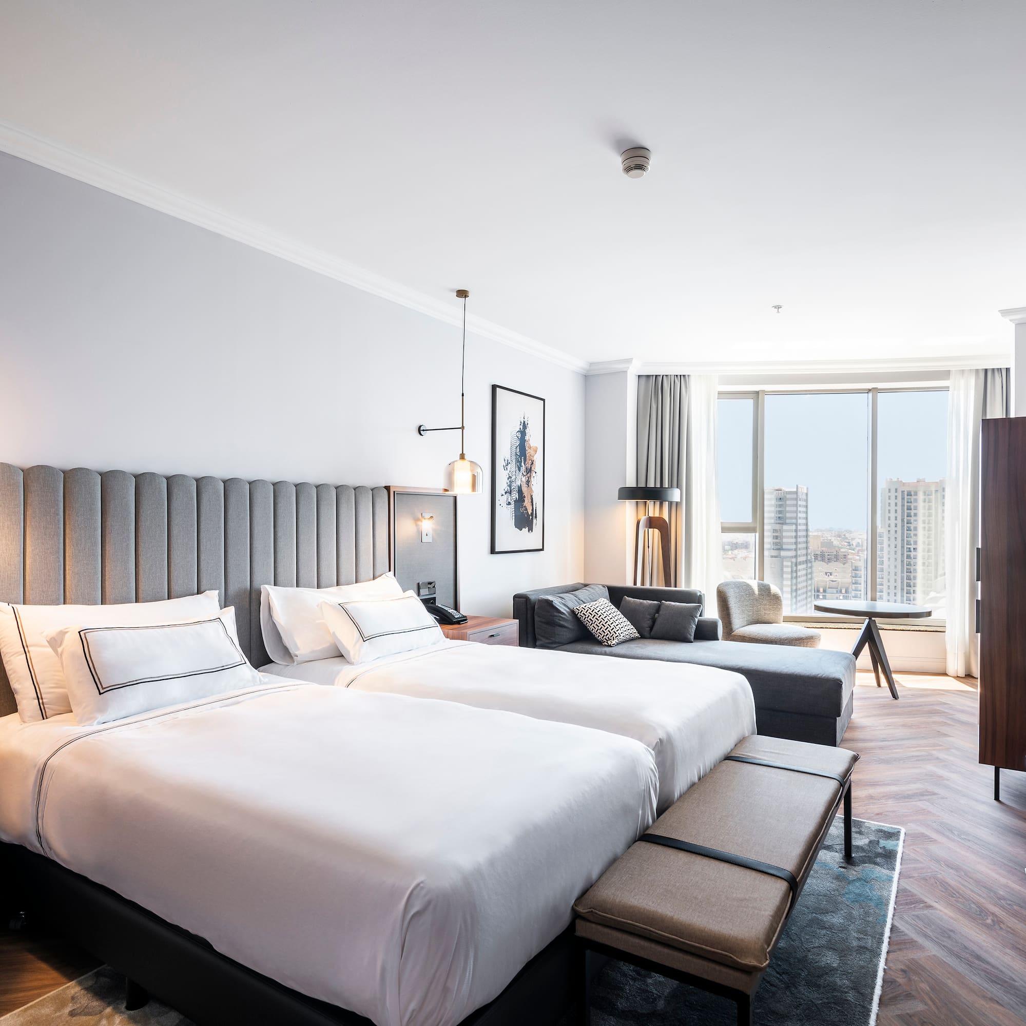 a room with two beds and a couch